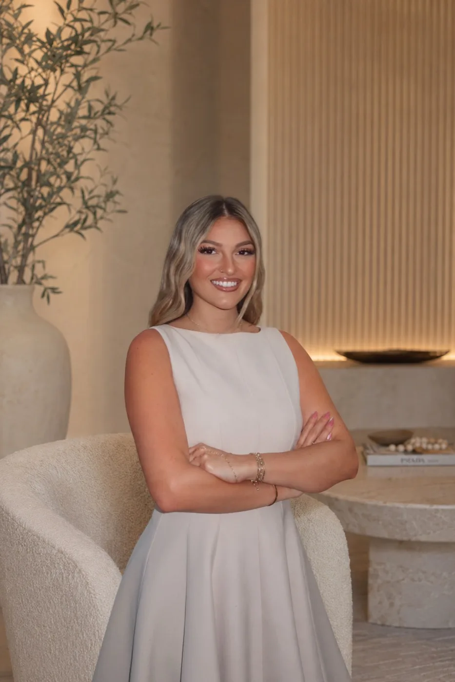 Helena Ciappina smiling in a cream dress