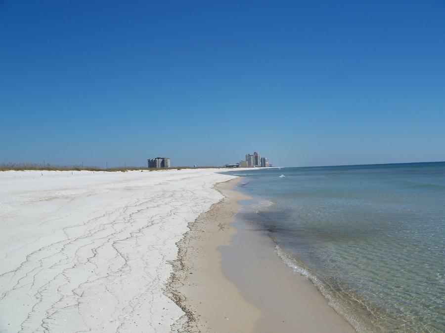 White sand Gulf beach with clear shallow water at Perdido Key State Park, looking east